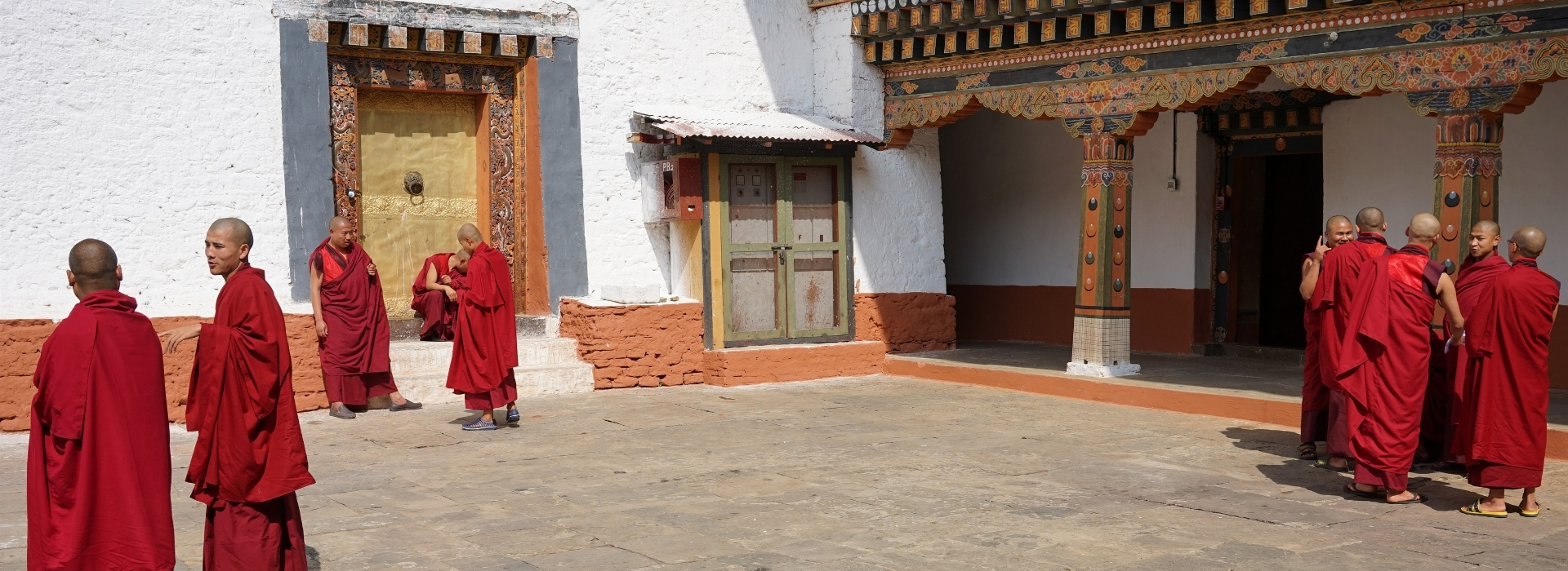 Buddhist monks gathered in a monastery courtyard in Bhutan